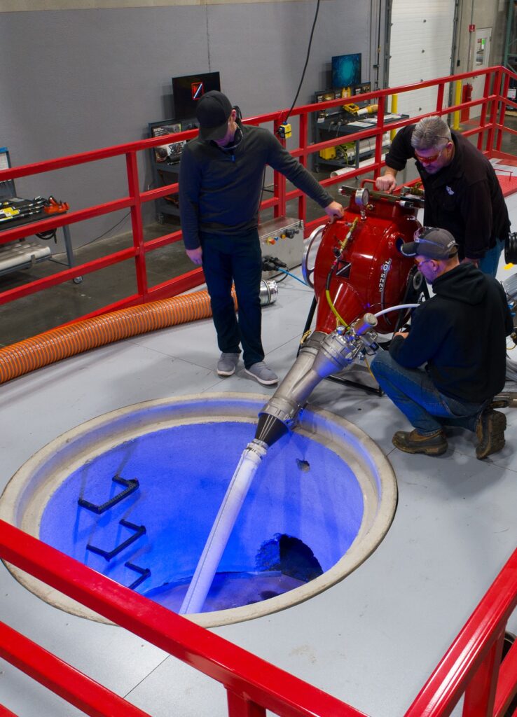 Technicians training with HammerHead BlueLight UV lining equipment