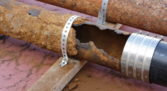 Deteriorated cast-iron pipe with a large section of pipe wall missing
